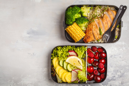 Healthy meal prep containers with grilled chicken with fruits, berries, rice and vegetables. Takeaway food.