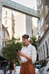 Fototapeta na wymiar Modern woman in urban city using smartphone 