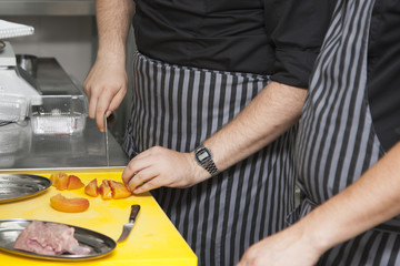 Hands chef preparing a dish of peaches