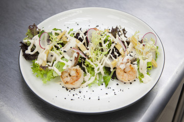 Cooks preparing a salad of seafood