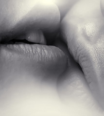 Lesbian kiss. Homosexual family. Women's lips close-up. Love and feelings. Lesbian love. Sensual kiss. Homosexual partner. A gentle touch of female mouth. Love between the girls