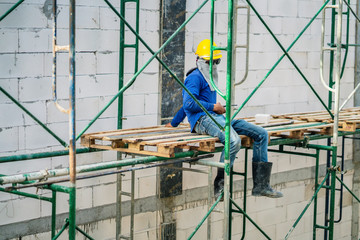 worker wear safty helmet take a break at construction site