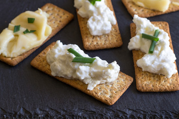 Cheese crackers with cottage cheese on slate