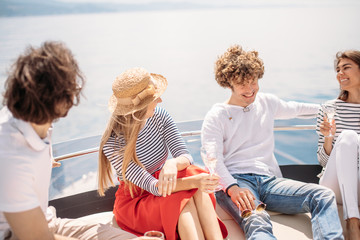 Happy young friends chilling in pleasure yacht - Relaxing people talking, enjoying sunny day and...