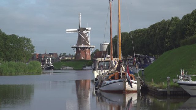 Windmill at a canal in Dokkum, Friesland, The Netherlands