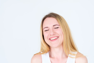 emotion face. very happy joyful thrilled to bits woman with beaming smile. young beautiful blond girl portrait on white background.