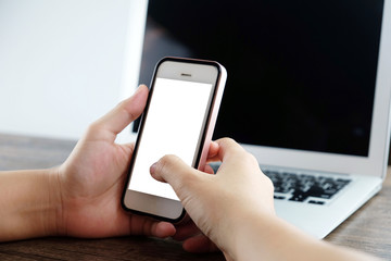 Hands of woman using smart phone at the office.