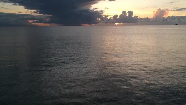 Full view of a beautiful, pink sunrise at 5AM at the ocean
