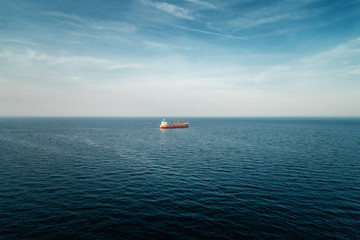 Cargo ship sailing in still water near port of Varna