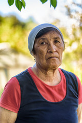 portrait of a sad elderly woman in the garden