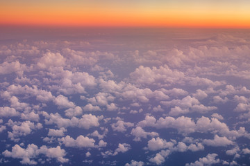 Fototapeta premium Flying above the clouds. Aerial view from the airplane