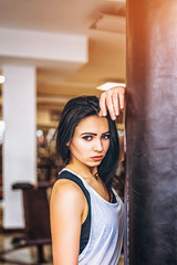 Obraz na płótnie Canvas Sporty girl near punching bag in the gym