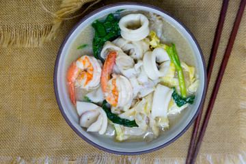 Fried noodle with egg, squid and shrimp soaked