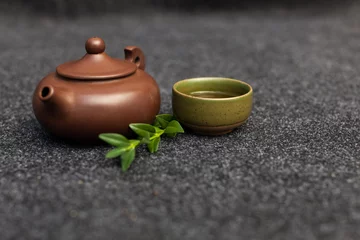 Foto op Aluminium Traditional tea ceremony accessories Chinese clay teapot with green and puer tea © Andrii