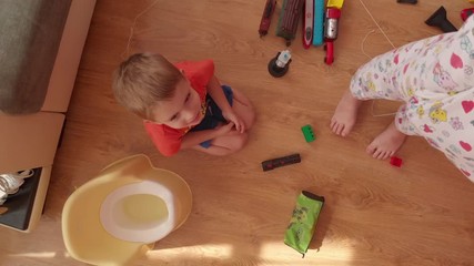 little boy is playing on the floor.