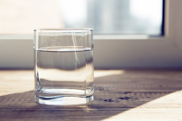 a glass of water on a table
