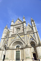 Fototapeta na wymiar Facade of the Cathedral of Orvieto (Duomo di Orvieto) Italy. Construction in Gothic style dedicated to the Virgin Mary