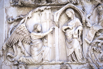 Detail of the facade of the Duomo of Orvieto, Italy. Marble bas-relief representing episodes of the bible.Annunciation