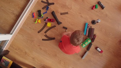 little boy is playing on the floor.