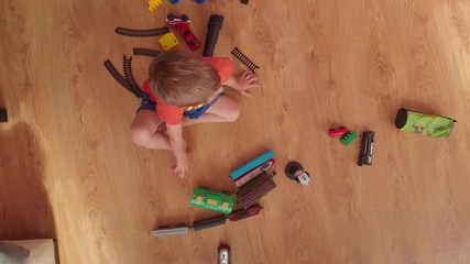 little boy is playing on the floor.