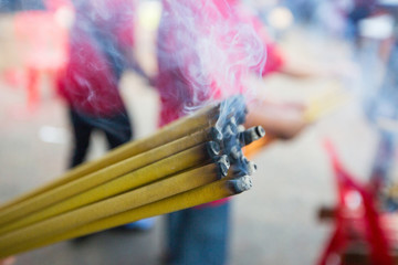 Incense burning Embossed in hand. There is a lot of smoke.