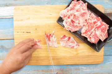 Chef slicing wagyu beef for cooking