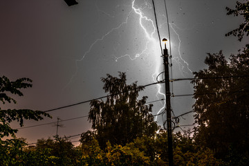 Strike of a strong lightning during a thunderstorm near
