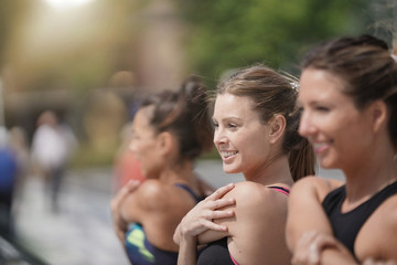 Group of joggers stretching out after running