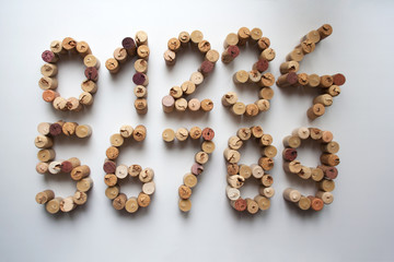 Wine cork numbers composition isolated on white background from a high angle view