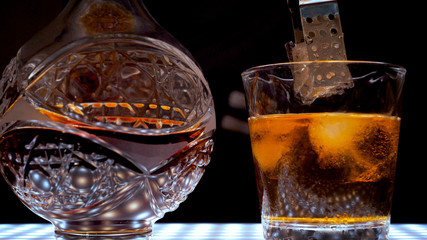 Decanter and a glass of whiskey with ice