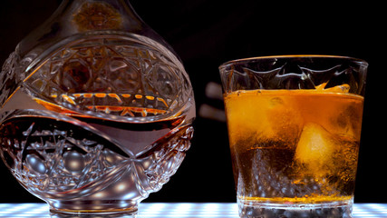 Decanter and a glass of whiskey with ice