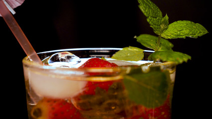 Lime, mint, strawberry, transparent glass, ice cubes.