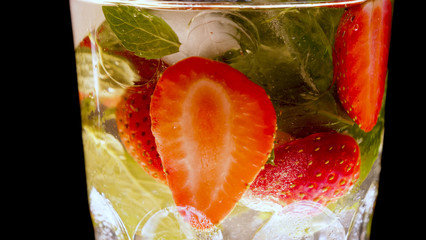 Lime, mint, strawberry, transparent glass, ice cubes.