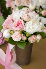 Brides bouquet with peony roses and ribbon.