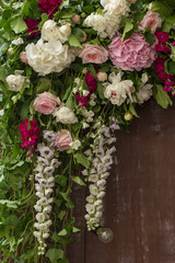 Wedding flowers decoration on brown wooden fence.