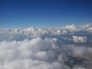 Fototapeta na wymiar Tranquil Beautiful View From Plane Window at Blue Sky over White Clouds