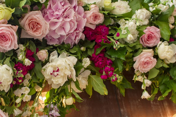 Wedding flowers decoration on brown wooden fence.
