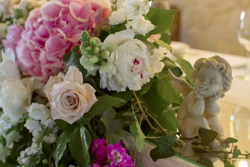 Wedding table decoration with angel flowers bouqet.