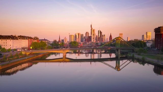 frankfurt aerial view at sunrise drone flying up over main river bridge
