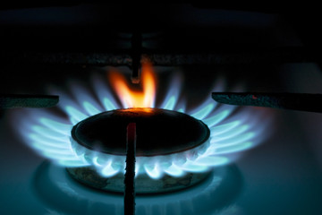 burning gas burner in the dark, with a red flame tongue, close-up