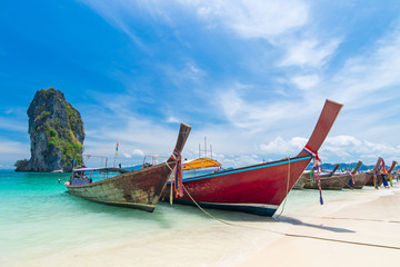 Fototapeta na wymiar Thai long tail boats on the beach with beautiful island, Krabi Phuket Thailand