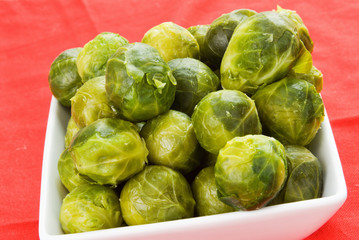 Brussels Sprouts in a White Bowl and Red Background