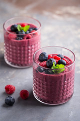 Mixed berry smoothie with mint on concrete background, close up