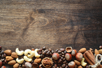Different nuts on a wooden table. Cedar, cashew, hazelnut, walnu