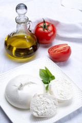 Fresh soft white burrata, ball buttery cheese, made from a mix of mozzarella and ricotta cream, original from Apulia region, Italy, very popular soft cheese in USA