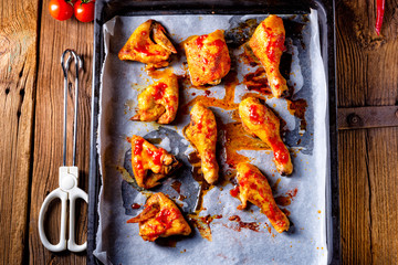 Rustic backed chicken wings,legs on baking tray