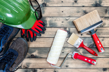 Professional house painter, tools and work equipment on wooden background © francescomou
