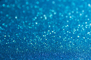 Closeup of glittery, blue, abstract surface. Shiny, rough texture glows in festive - holiday style