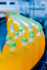 Conveyor with bottles for juice or water. Beverages factory equipments