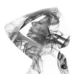 Double exposure portrait of a woman gently touching her hair and a smoky texture